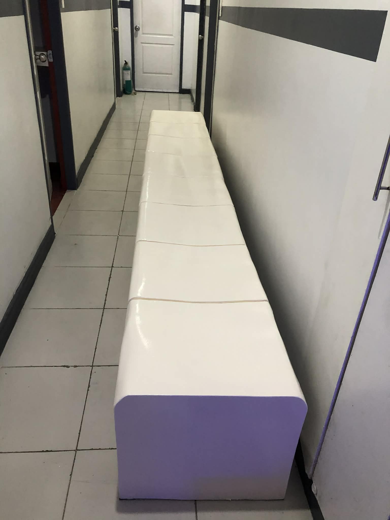 Modern white hotel bench with sleek metalwork design
